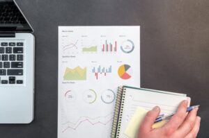 el punto de vista de una persona analizando resultados de una compañía en hojas y libretas